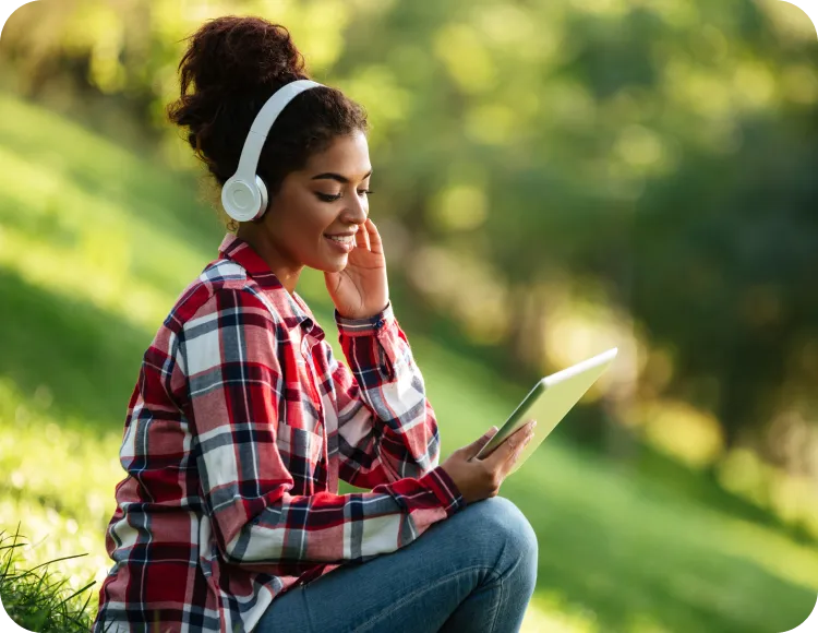 Student learning French with headphones and a tablet
