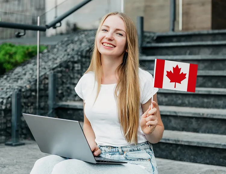 Student holding a Canadian flag